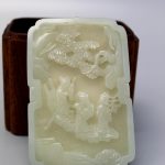 Chinese wood box with carved white jade cover.